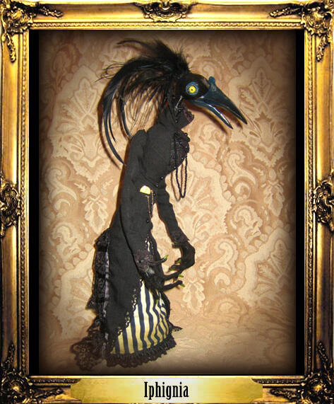 A tall thin Victorian doll dressed in black and white striped finery and a black lace tail coat with a pocket watch and beaded necklaces has the head of a strange bird with staring eyes and large black plumes