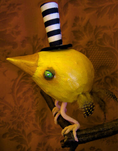 A fat yellow bird in the shape of a teardrop, with beady yellow eyes, tiny feathered wings and tail, perched on a branch sprouting from a wooden plaque on the red wall background, and wearing a very very tall black and white striped tophat.