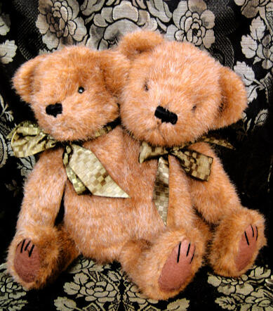 Two-headed conjoined twin mohair teddy bear with green bows around their necks